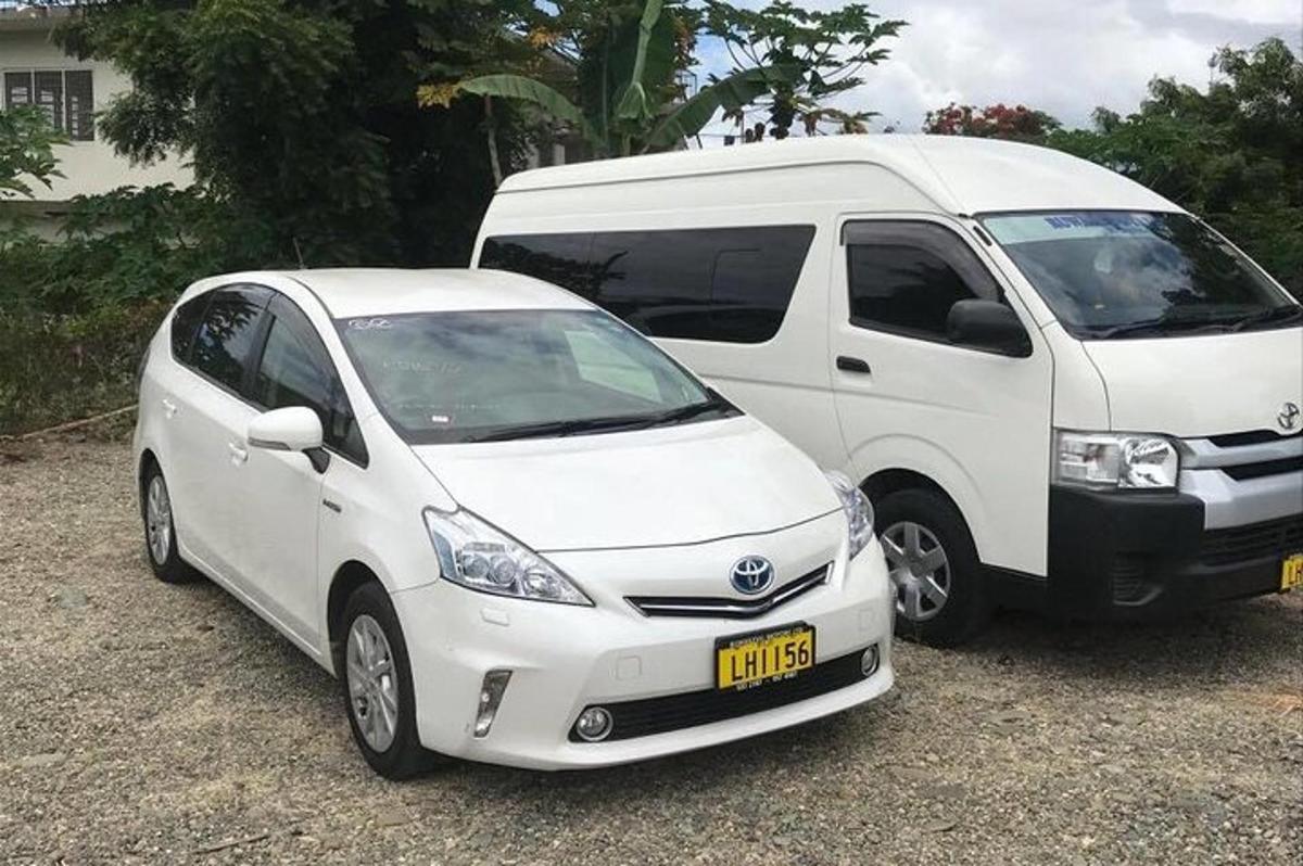 a white car parked next to a white van