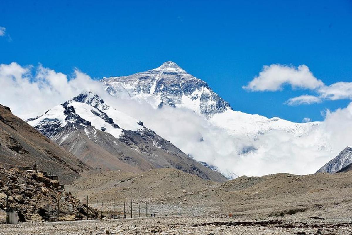 a snow covered mountain in the middle of a valley
