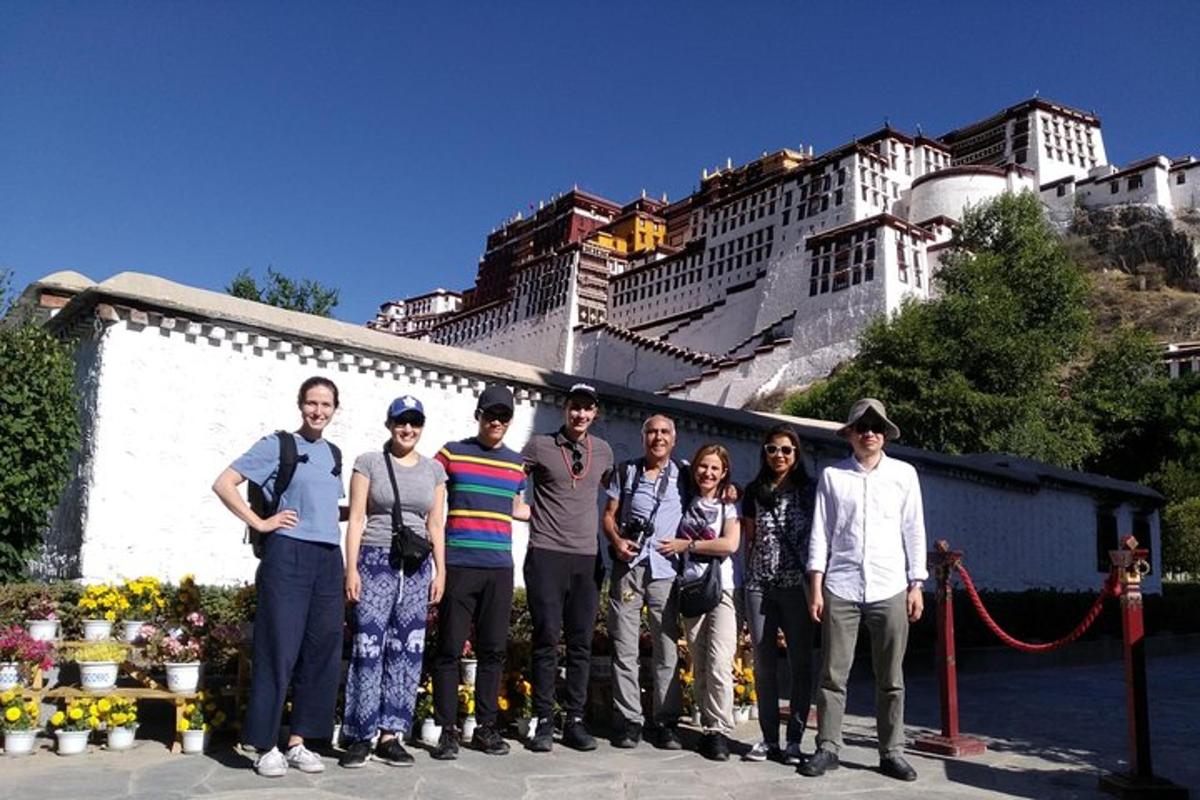 a group of people posing for a picture in front of a building