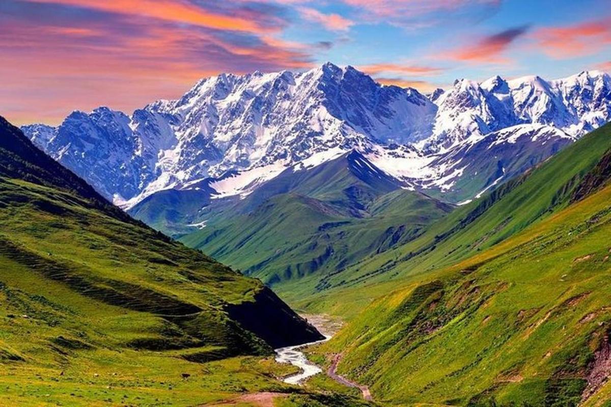a view of a mountain range with snow covered mountains