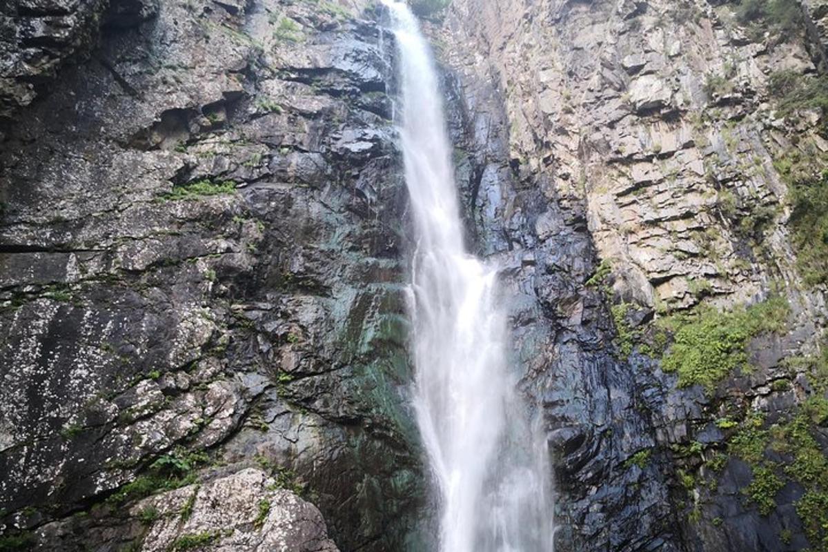 a waterfall on the side of a rocky mountain