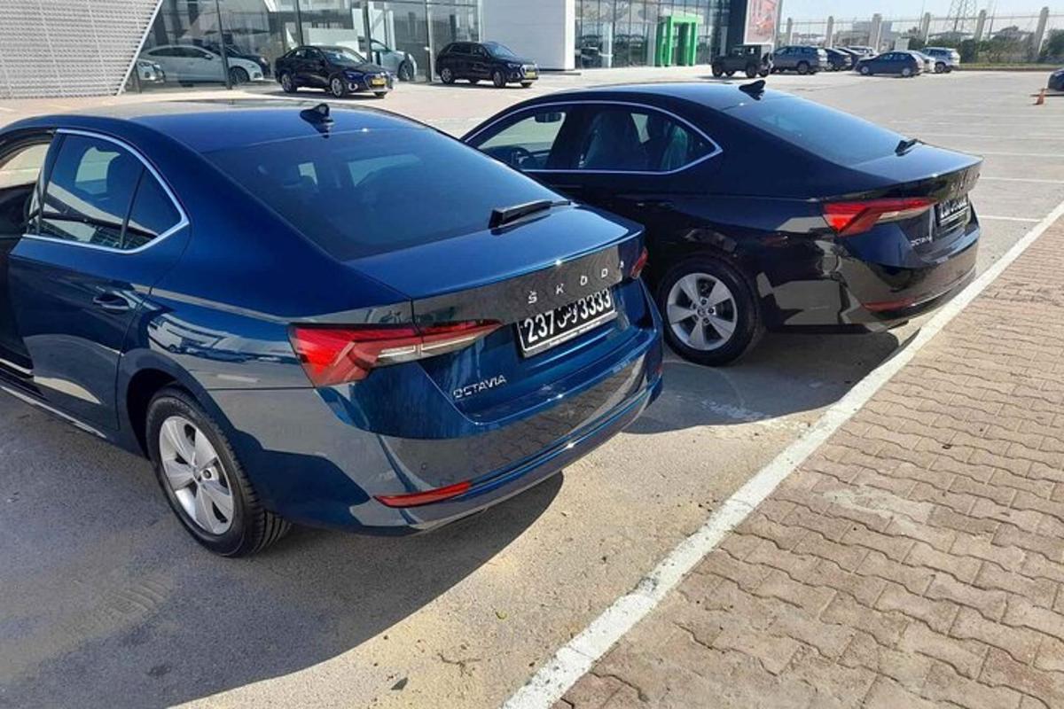 two cars parked next to each other in a parking lot