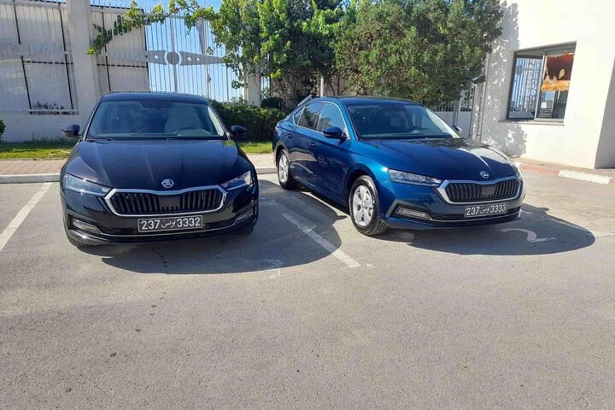 two cars parked next to each other in a parking lot