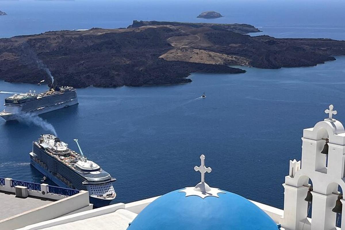 a cruise ship in the water next to a church