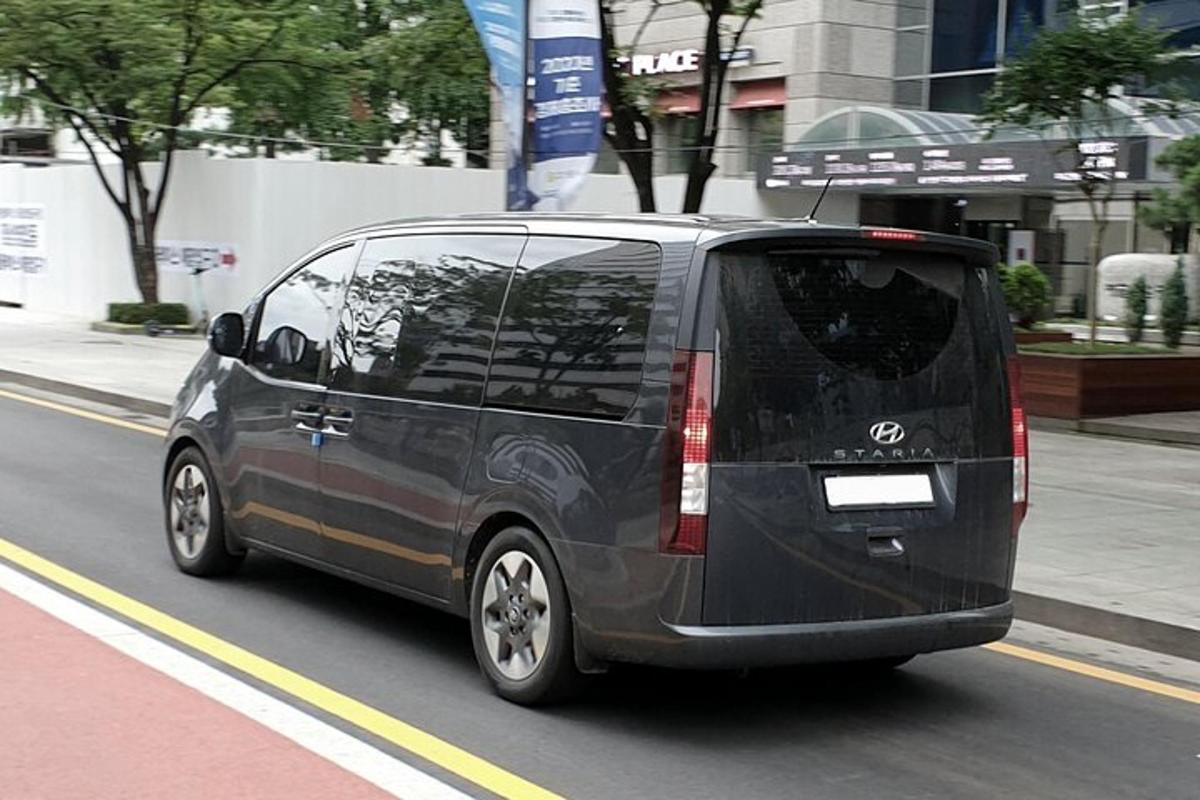 musta pakettiauto ajaa kaupungin kadulla