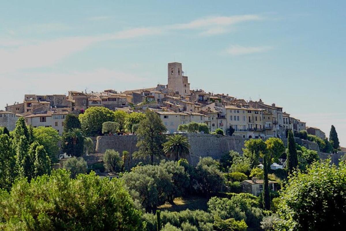 a town on top of a hill with trees and buildings
