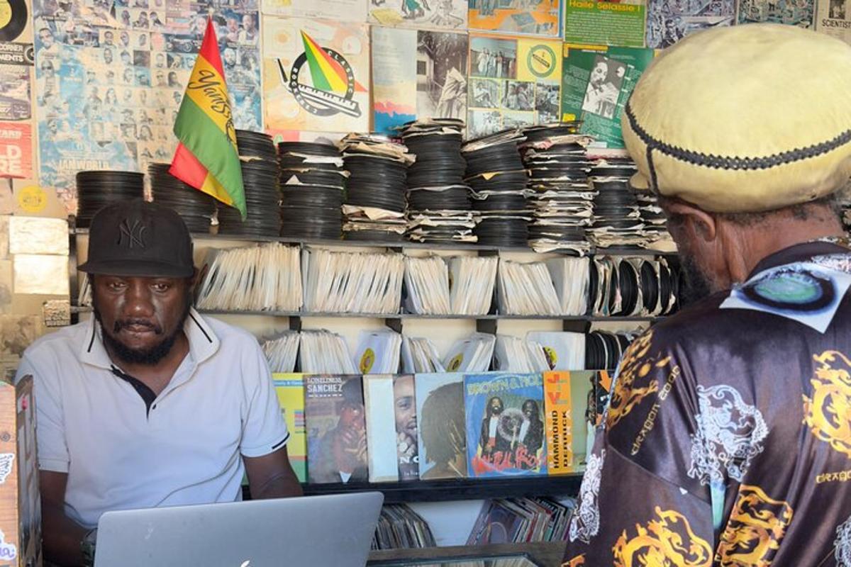 a man working on a laptop in front of a vendor