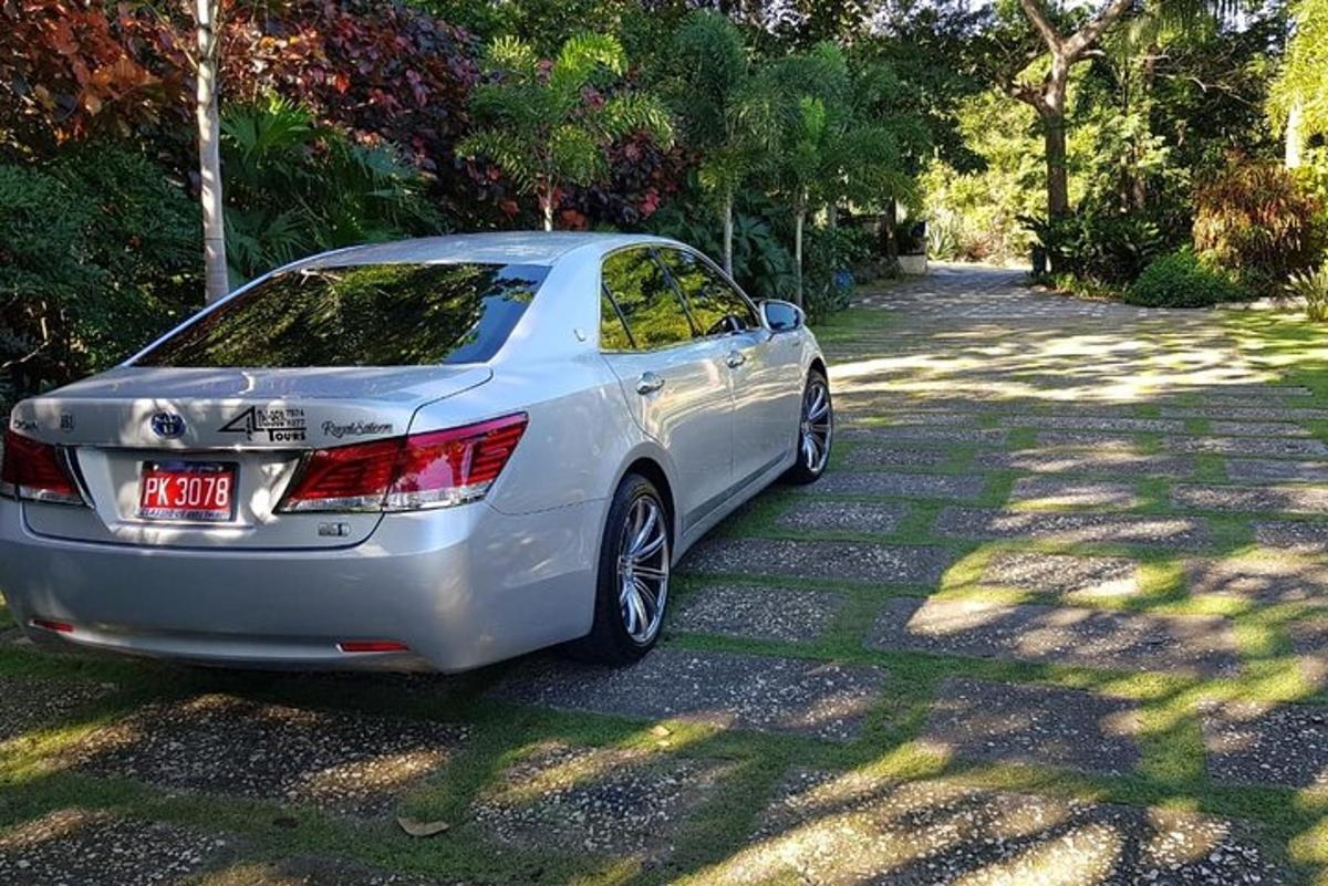 a silver car parked on a gravel road
