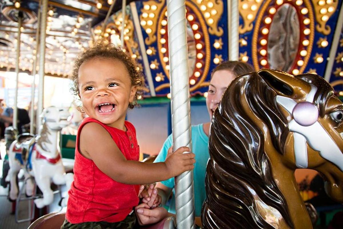 a little girl is playing on a carousel