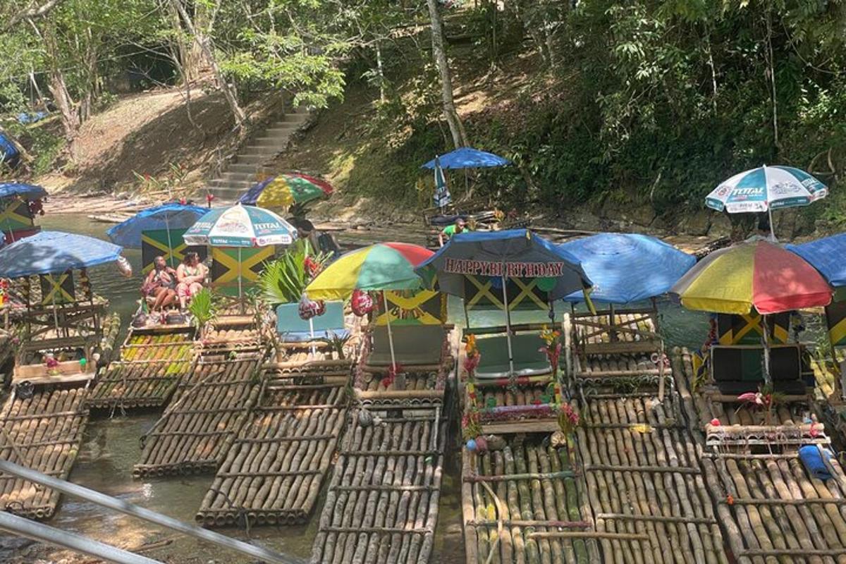 a bunch of chairs in the water with umbrellas