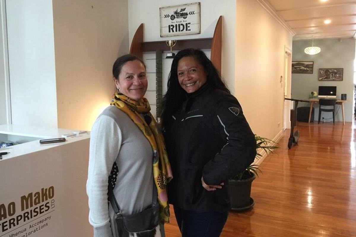 two women standing next to each other in a hallway