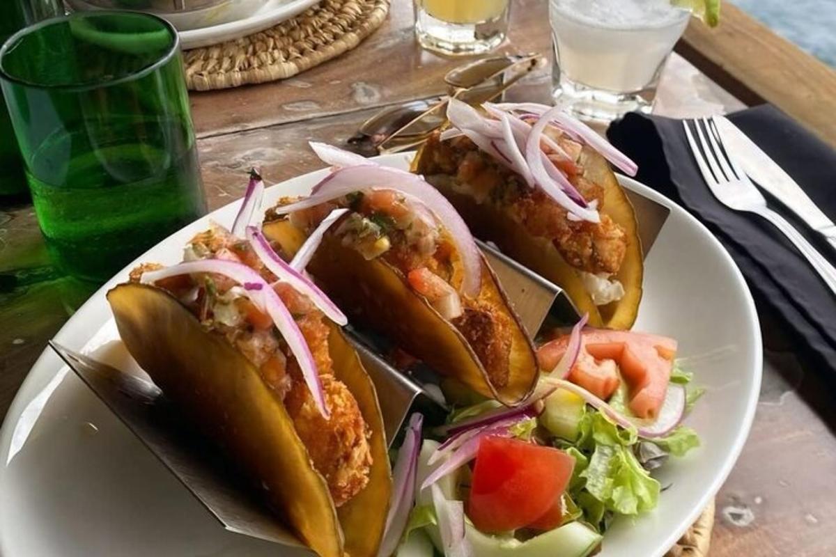 a plate of food with three hot dogs and a salad