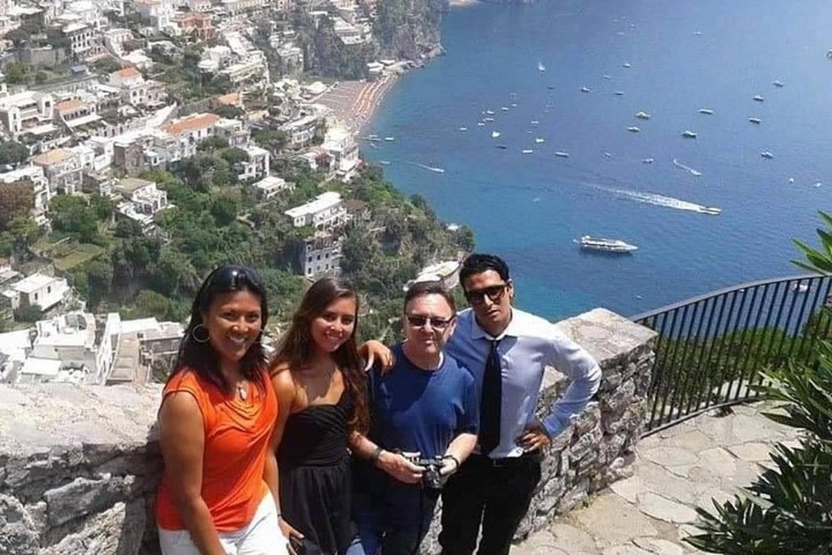 a group of people standing on the edge of a mountain