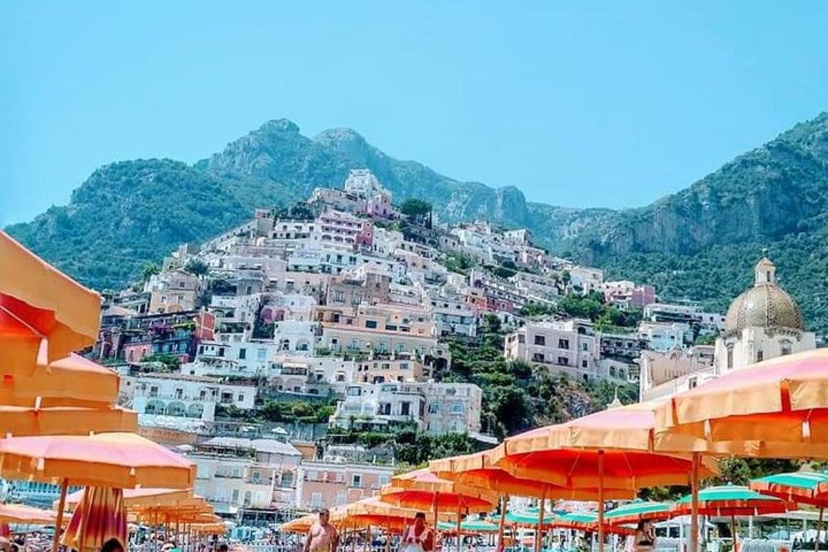 a group of buildings on a hill with umbrellas