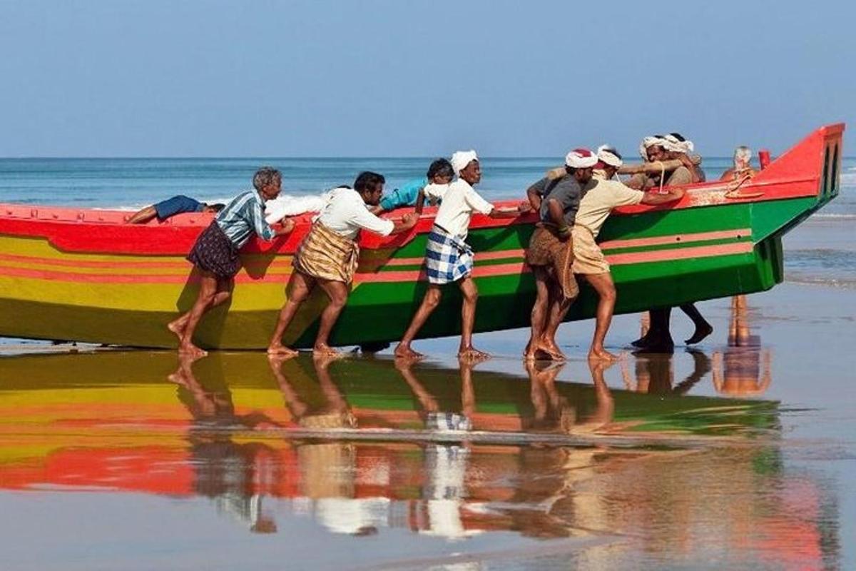 a group of people on a boat on the beach