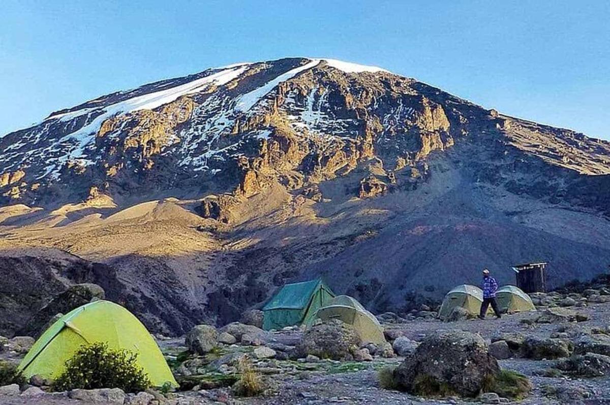 a group of tents in front of a mountain