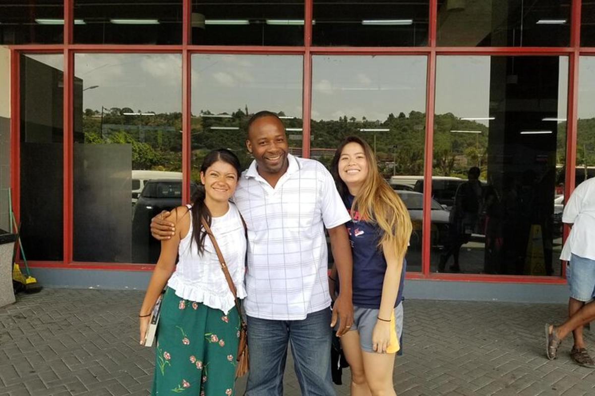 three people posing for a picture in front of a building