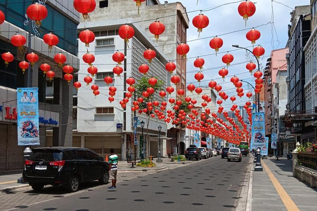 a street with red lanterns hanging over a street