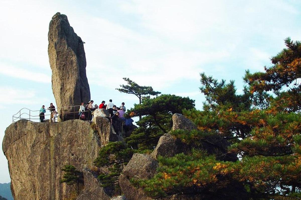 a group of people standing on top of a mountain