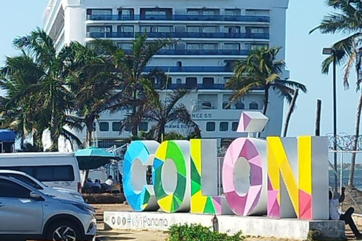 a car parked in front of a building with a sign