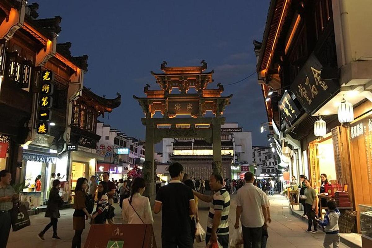 a group of people walking down a street at night