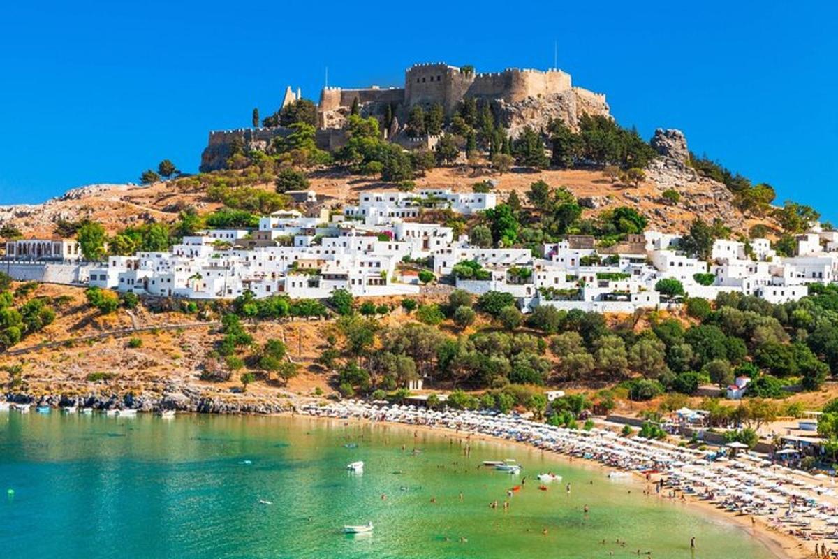 a view of a beach with a castle on a hill