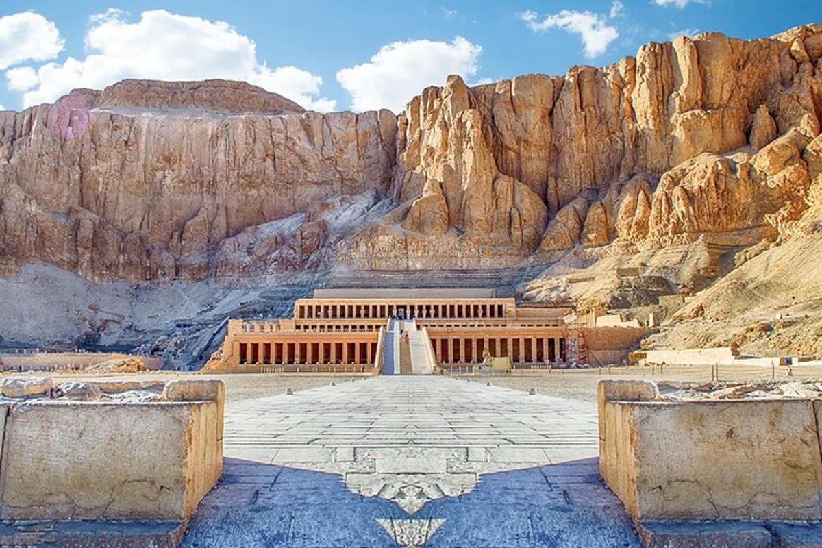 a view of a building in front of a mountain