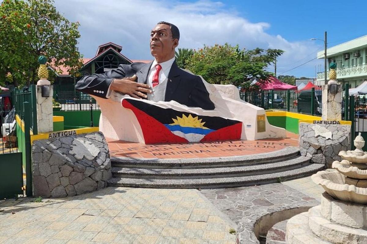 a statue of a man in a suit sitting on a bench