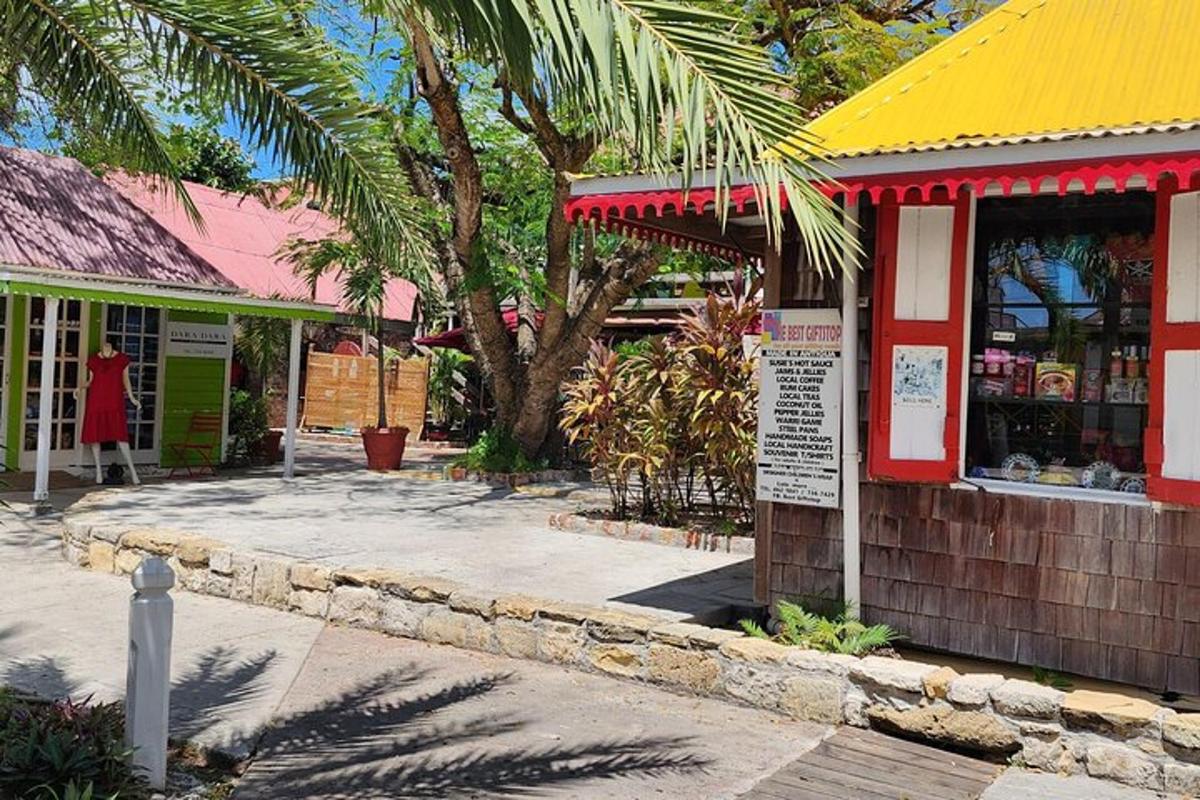 a store with a yellow and red roof and palm trees