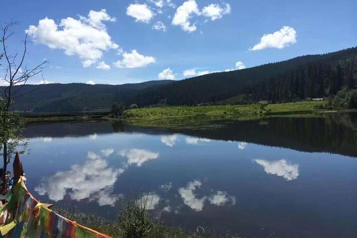 a view of a lake with clouds in the water