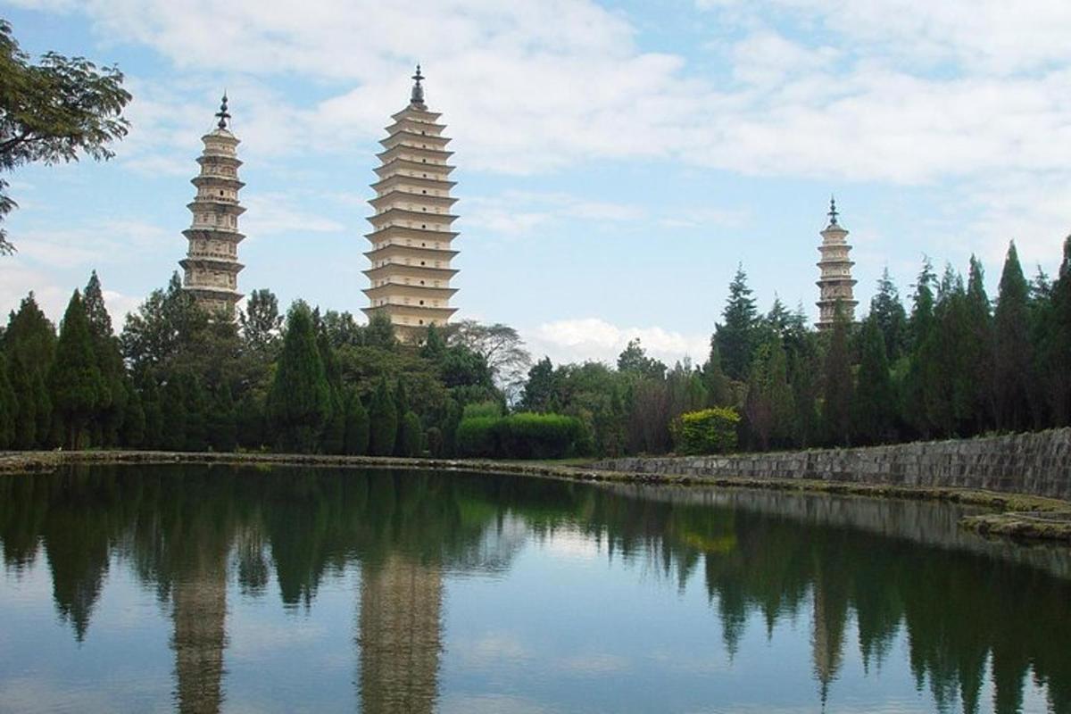 a group of pagodas sitting next to a body of water