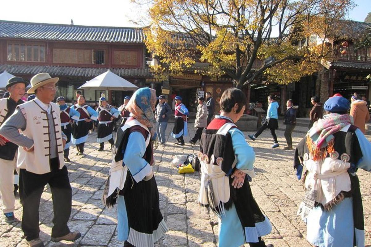 a group of people dressed in costumes standing in a courtyard