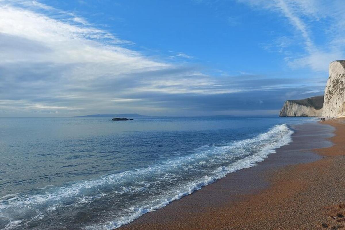 a sandy beach with a view of the ocean