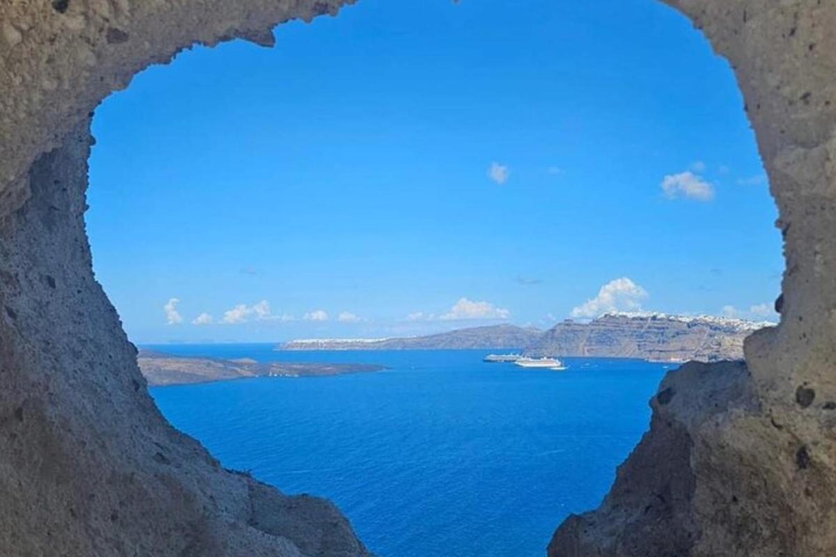 a view of the ocean through a hole in a cliff