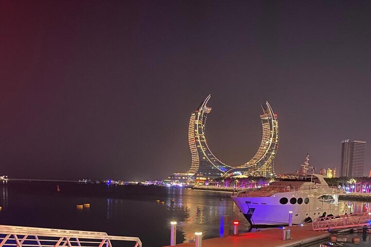 a large boat is docked in a harbor at night
