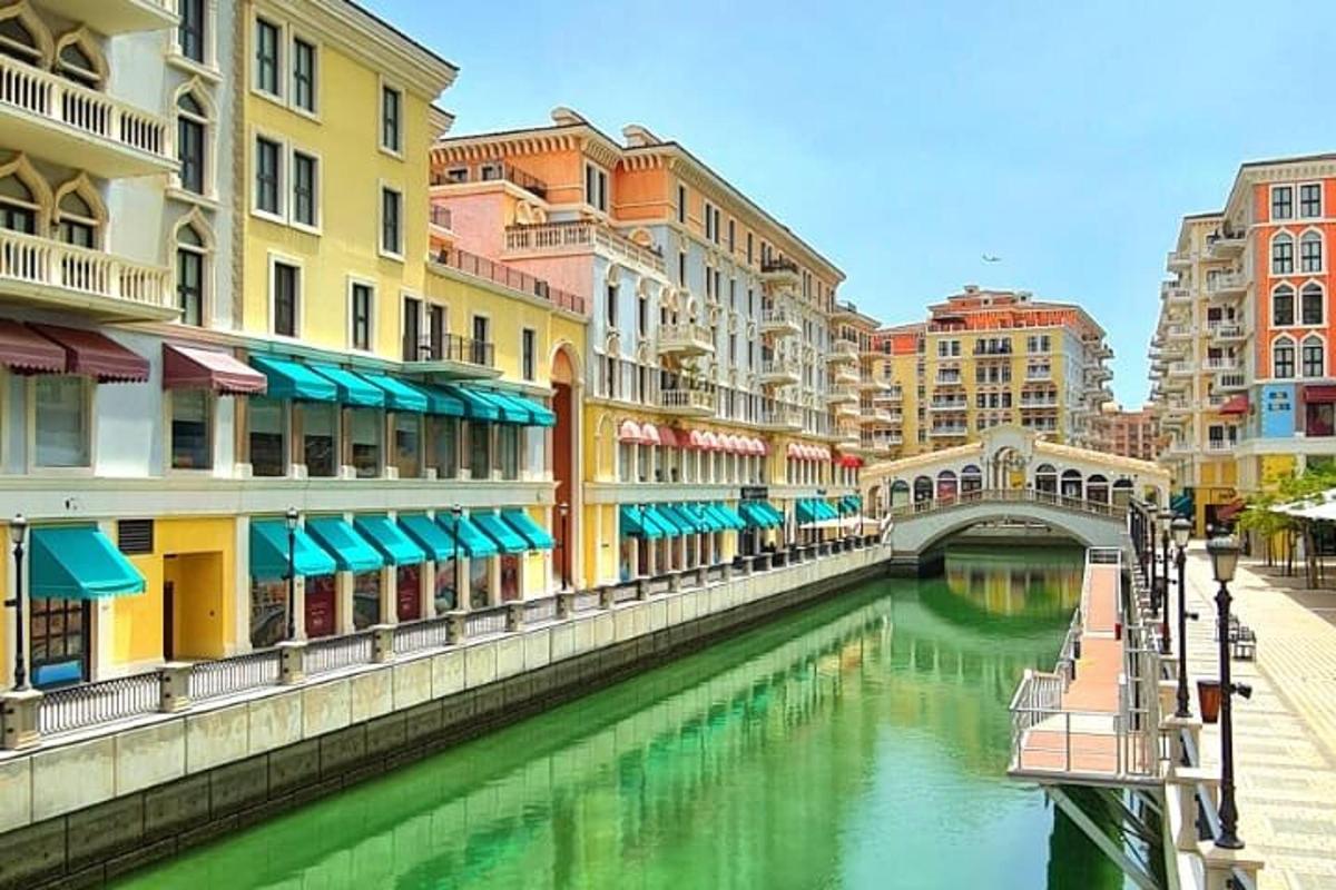a river in a city with buildings and a bridge