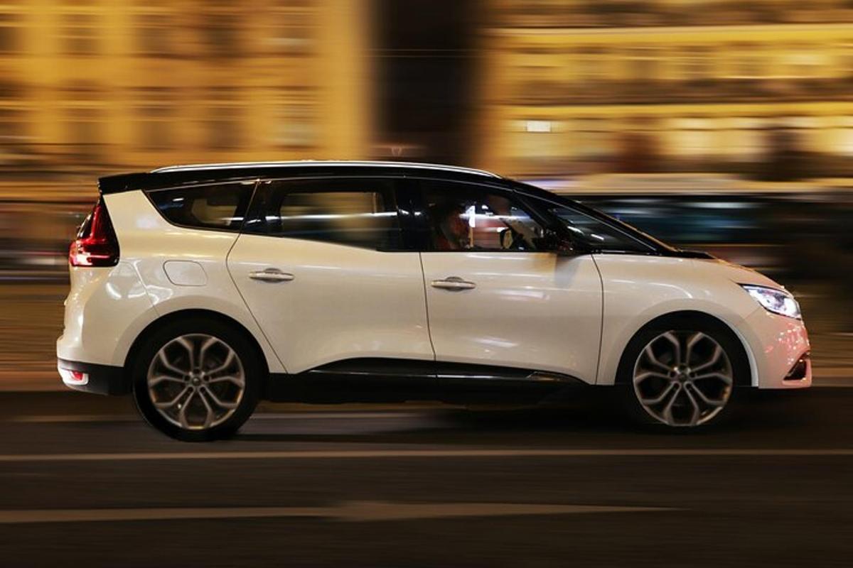 valge auto sõidab mööda tänavat