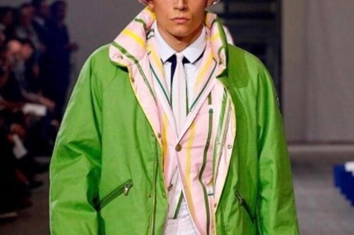a man wearing a green jacket and a tie