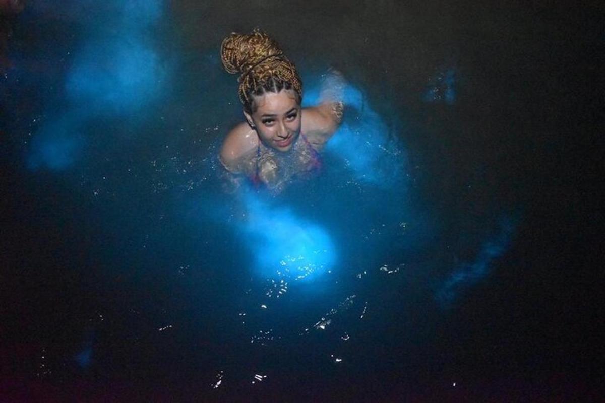 a young girl swimming in a pool of water