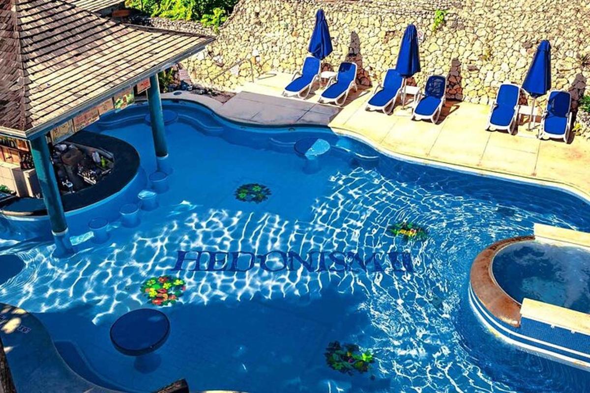 a pool with chairs and a swimming pool