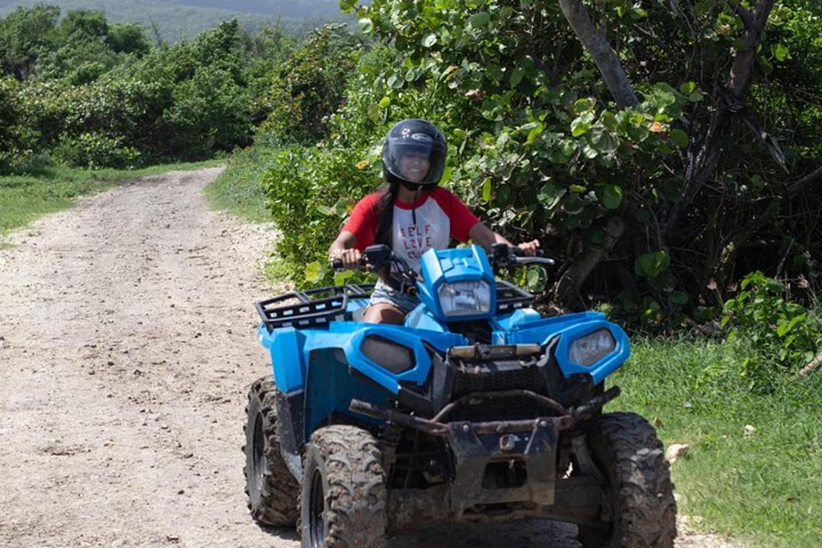 a person riding a four wheeler on a dirt road