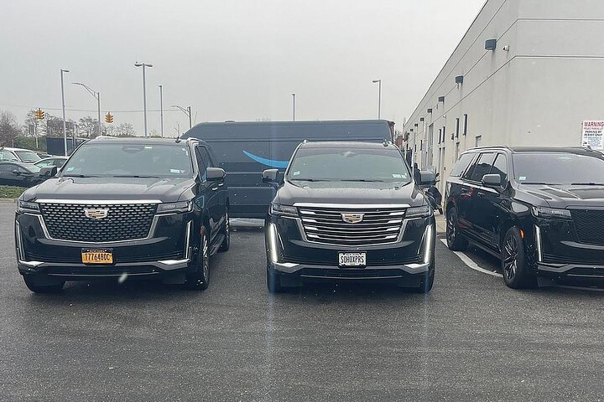 three trucks are parked in a parking lot