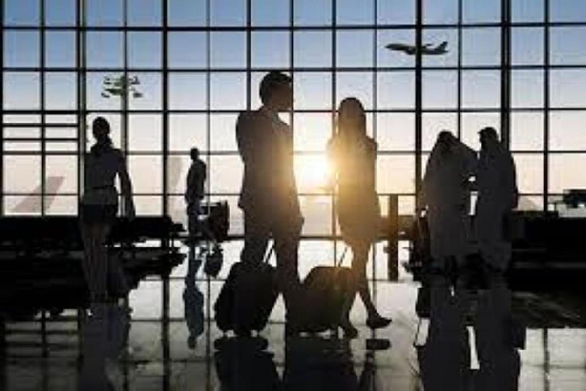 a group of people standing in an airport