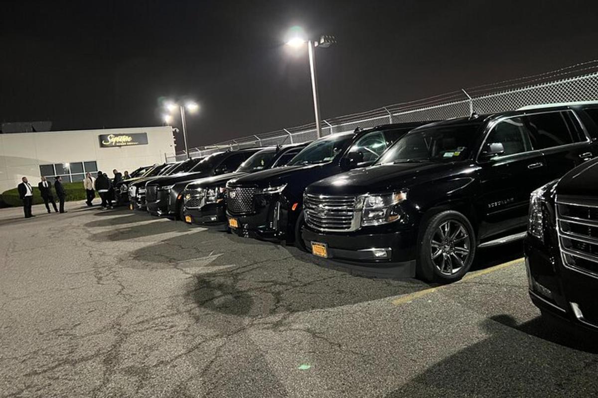 a row of trucks parked in a parking lot at night