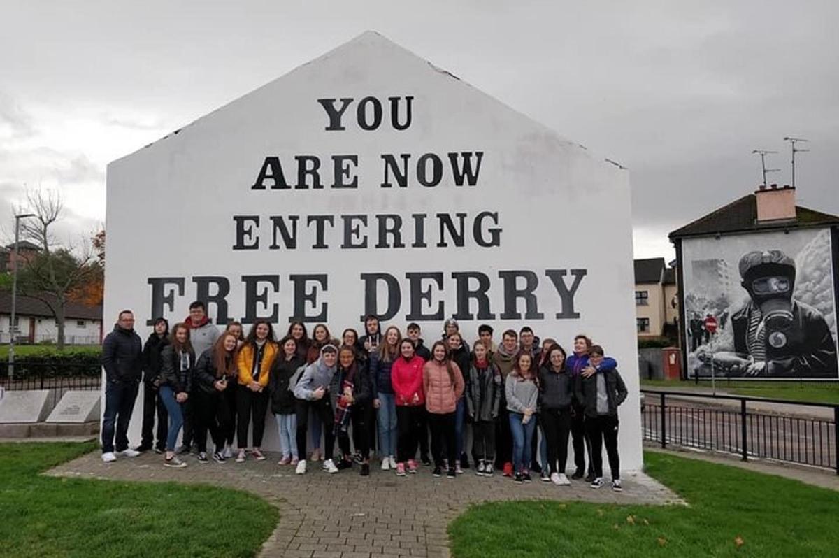a group of people standing in front of a sign
