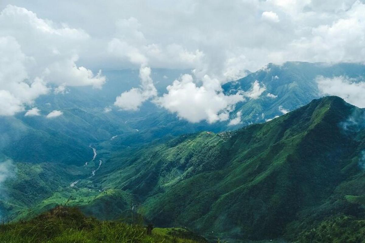 a view of a mountain range with clouds in the sky