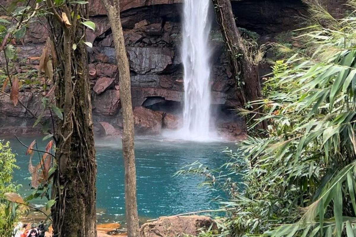a waterfall in the middle of a pool of water