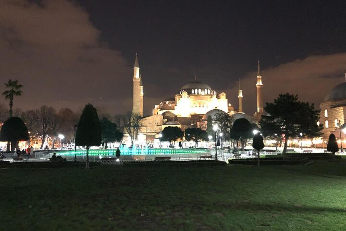 a view of a building with a mosque at night