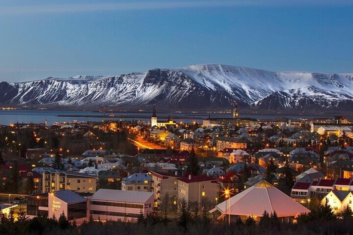 a city with snow covered mountains in the background