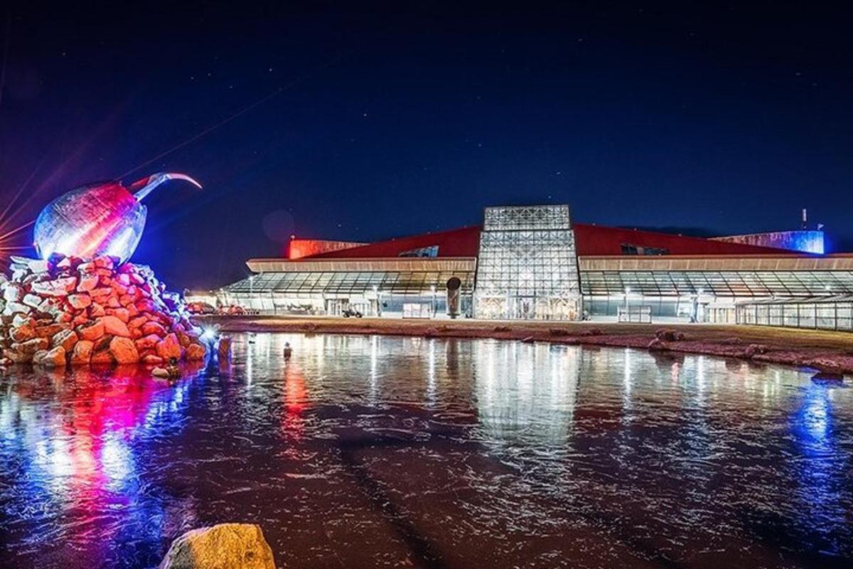 a large building with a building with lights in the water